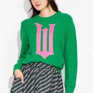 Women’s graphic sweater in green w pink graphic “W” from the movie Wicked Small